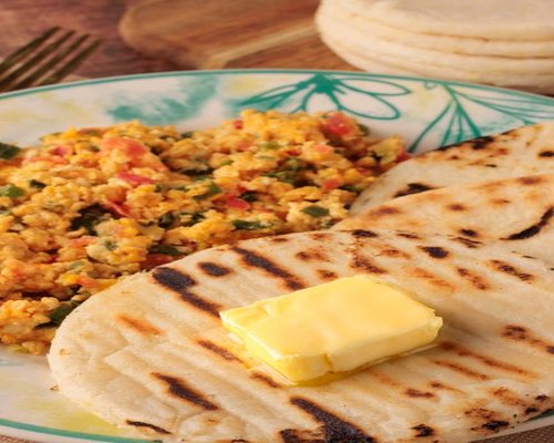 Colombian traditional home-cooked meal with arepa and vegetables